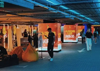 Attendees walking through a brand activation lit in orange and blue
